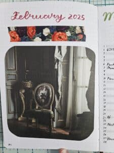 Single journal page that says February 2025 a the top, a strip of floral patterned tape underneath, and a large picture of an elegant chair next to a window